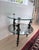 Elegant vintage Hollywood Regency style side table featuring sculptural cherub supports, decorative faceted glass accents,...