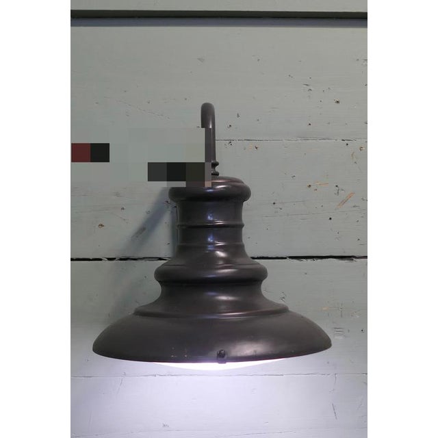 A Large Gun Metal Industrial Wall Light This Industrial wall light hangs from a robust swan neck bracket and it has a...