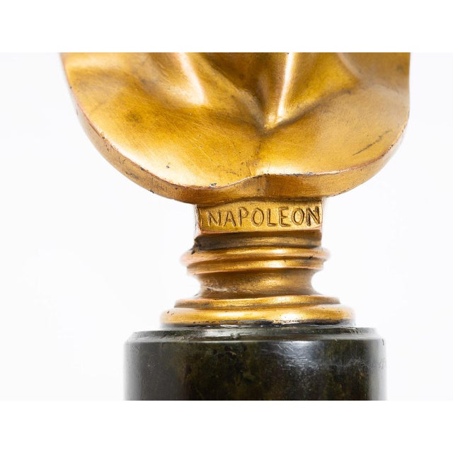 Description: Antique gilded bronze sculpture depicting Napoleon Bonaparte resting on an antique green marble base. The...