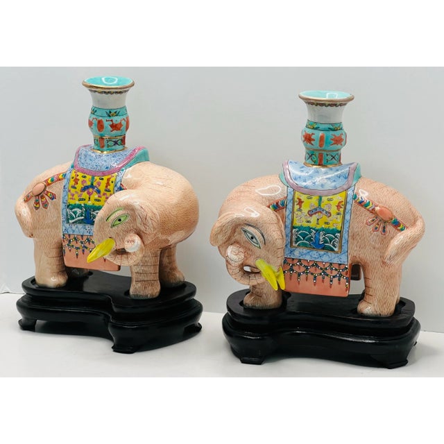 A delightful pair of Mottahedeh famille rose enameled porcelain candle holders The whimsical pair of candleholders each...