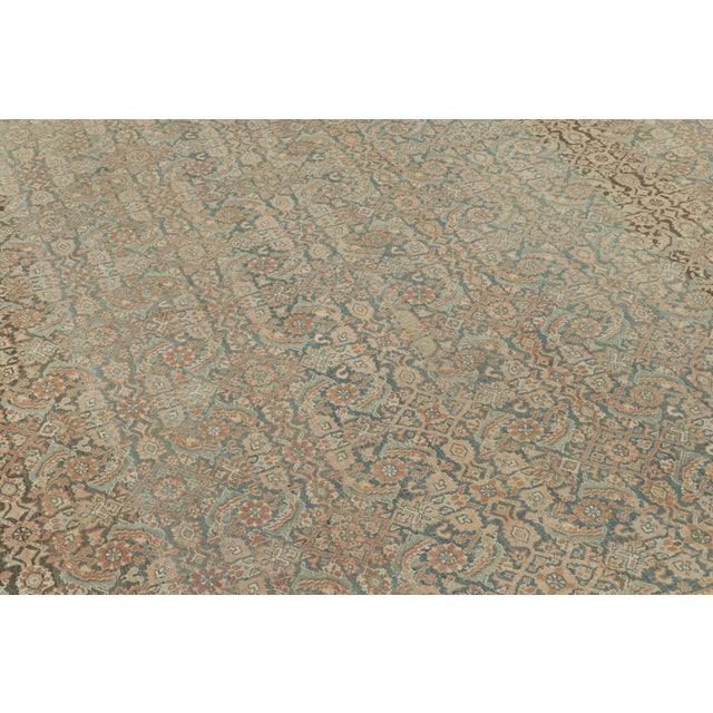 Handwoven in wool, circa 1900–1920, this antique 8x9 Malayer rug features an intricate all-over floral design with angular...