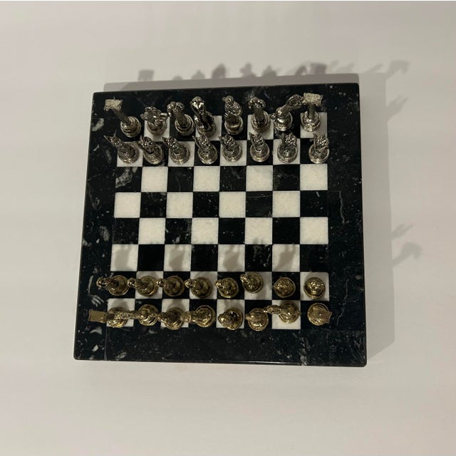 A collectible Florentine chess set featuring intricately cast figures depicting classical Greco-Roman warriors and gods —...