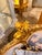 French Louis XVstyle canapé settee, beautifully crafted with an elaborately carved frame, rich gold finish, and elegant...