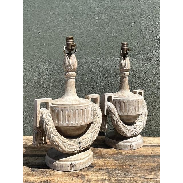 This exquisite pair of table lamps draws inspiration from Neoclassical and Directoire design, featuring a classic urn...