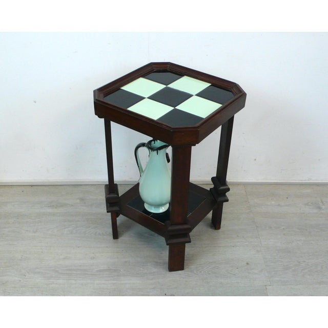 Art Deco side table/plant stand in dark walnut with black and mint tiles from the 1910s-1920s, in original condition. The...