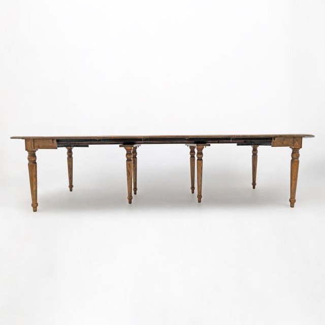 Impressive antique extendable dining table crafted from elm wood and originating from Tuscany, Italy. When fully closed,...