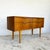 Compact teak sideboard by Frank Guille for Austinsuite, England circa 1960s. Four drawers arranged as two pairs with...