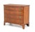 Late George III English chest of drawers crafted in fruitwood with contrasting crossbanded drawer fronts and top. Features...