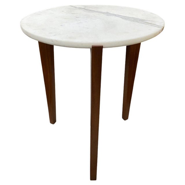 Minimalist one inch thick Italian marble top rests on solid walnut legs. From the Made in New York Collection. Own an...