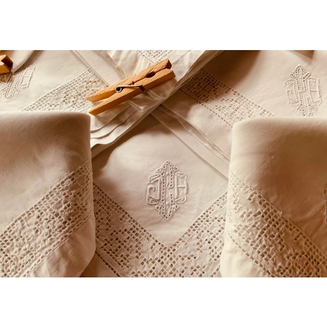A breathtaking set of eight pristine French linen napkins from circa 1930, these extraordinary pieces represent the...