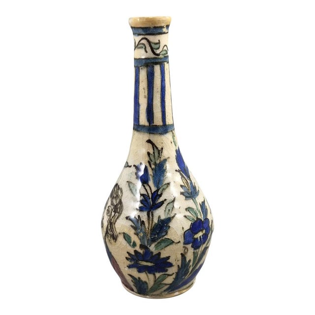 A striking pottery bottle vase from the Qajar period, dating to c. 1850–1880. Hand-thrown from a white siliceous...