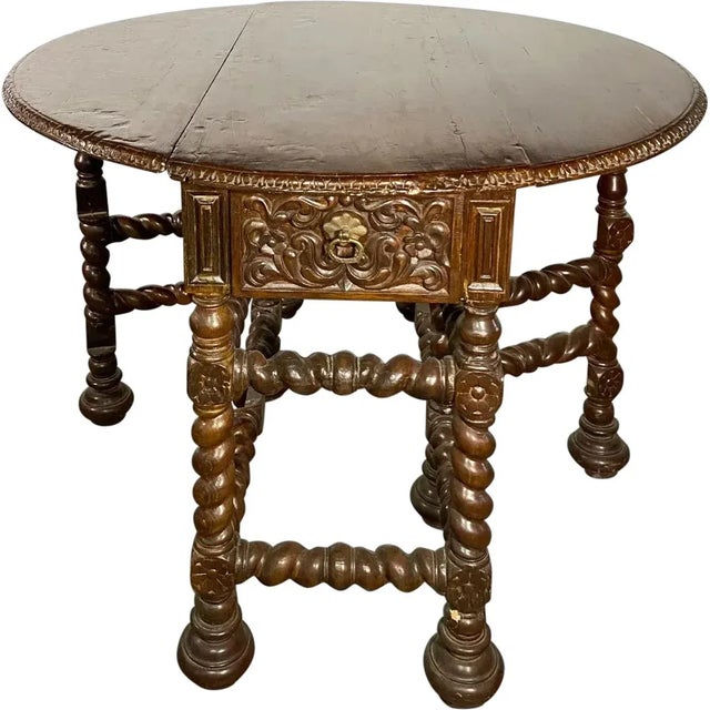This extraordinary antique, 17th century, gate-leg table, found in India, features an egg-and-dart rim on the oval, drop-...