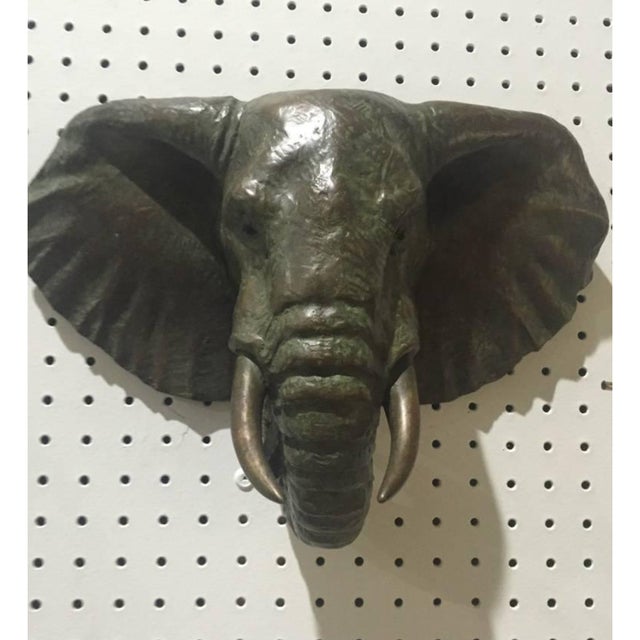 Pair of Mid-Century bronze elephant heads. Verde and gold patina. Incredible details. Slight color variation between the...