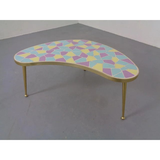Iron & ceramic manufactured kidney-shaped table from the 1950s. Legs can be unscrewed. Very nice, fully finished living...