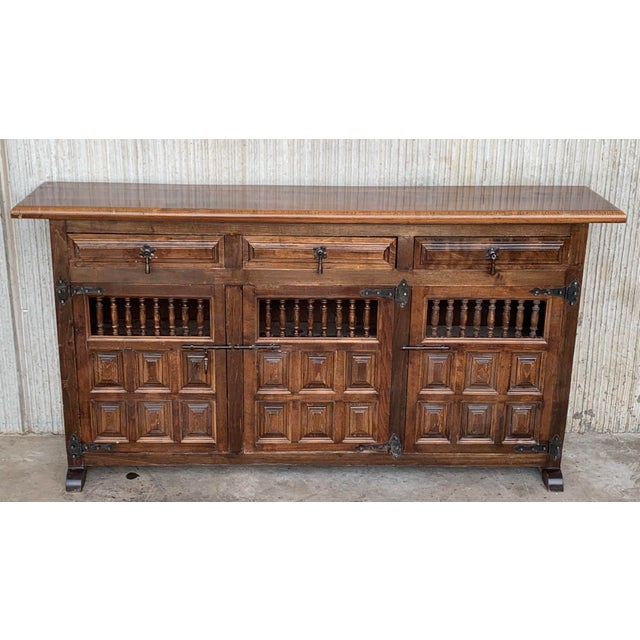 From Northern Spain, constructed of solid oak, the rectangular top with molded edge atop a conforming case housing three...