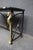 Maison Charles style console table featuring a black steel frame, brass seahorse-form supports, and a rectangular verdi...