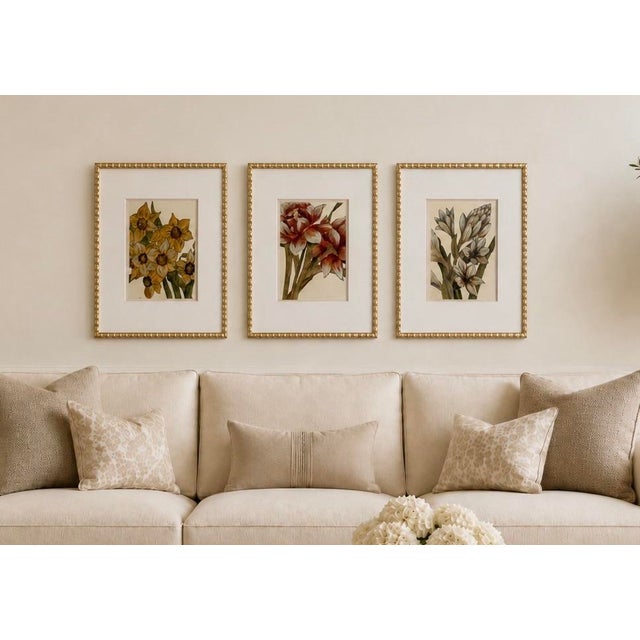 Elegant set of three framed botanical prints by Lauren Galleries, each featuring a different floral composition in a...