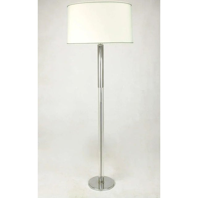 Sleek floor lamp in chromed steel and Lucite in the manner of Walter Von Nessen. 9.5" diameter chrome base with 2"...