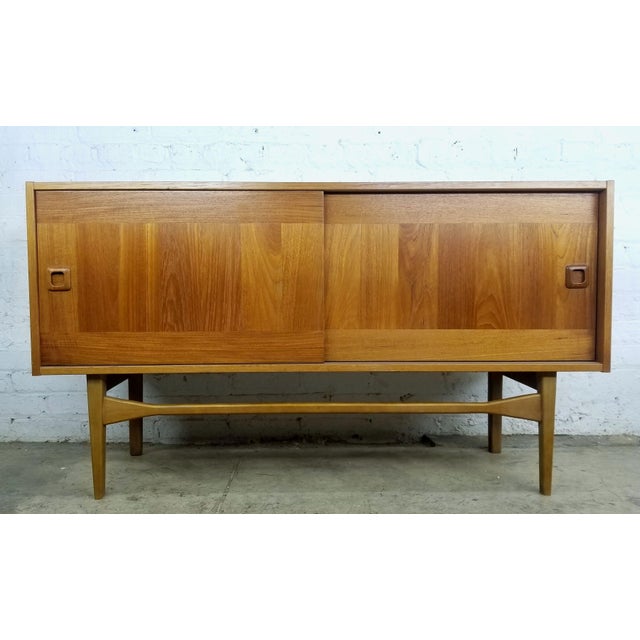 Slick, versatile and beautiful Danish modern mid century teak credenza / buffet / bar cabinet with compact foot print. LOW...