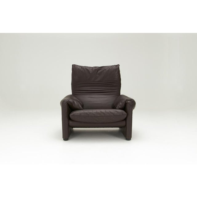 A 'Maralunga' Armchair in brown leather upholstery, designed by Vico Magistretti for Cassina in the 1970's. ​It has an...