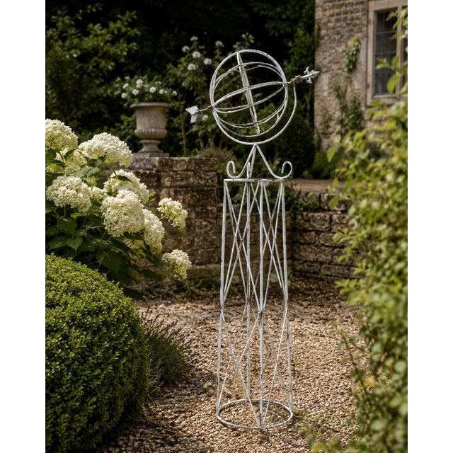 A beautifully crafted iron armillary sphere on stand, evoking the timeless elegance of classical European gardens. Pieces...