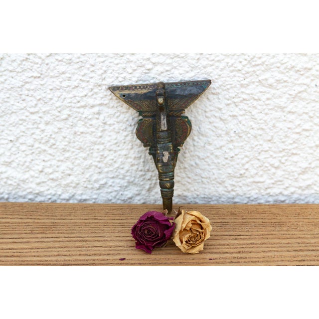 A robust utilitarian antiquity featuring a detailed geometric stem and a stylized architectural bud finial, carrying a...