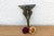 A robust utilitarian antiquity featuring a detailed geometric stem and a stylized architectural bud finial, carrying a...