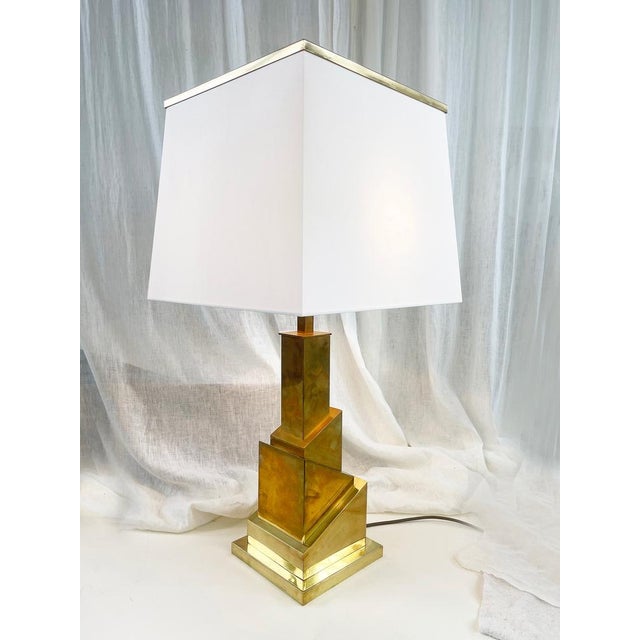 This impressive desk or table lamp is made of brass and features an art deco to hollywood regency style with a hint of mid...