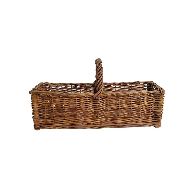 Add timeless European charm to your home with this vintage French wicker gathering basket, sourced from France. Handwoven...