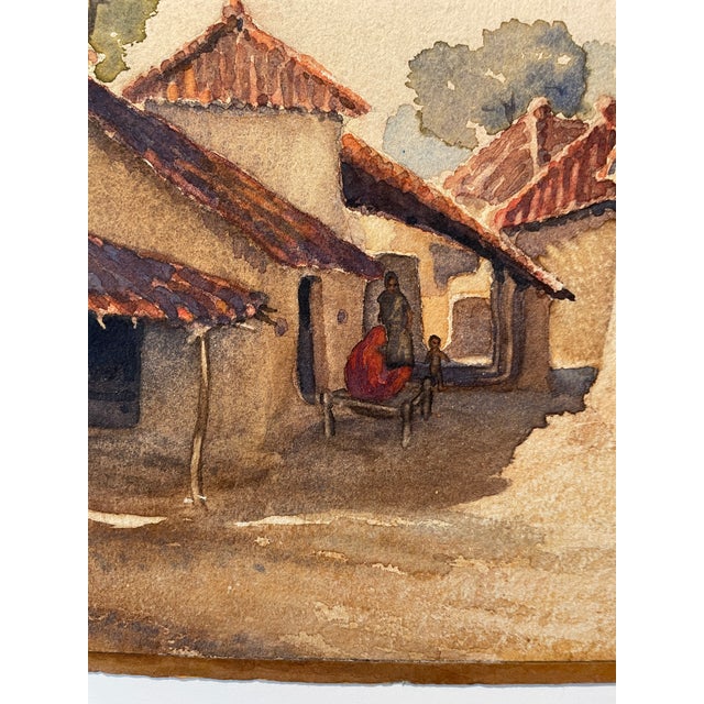 Watercolor on paper by Frank Wesley of a village scene with figures titled on the back "The New Baby." Signed and dated...