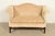 A gorgeous Chippendale style camelback upholstered loveseat or sofa with carved mahogany legs and stretchers By Ethan...