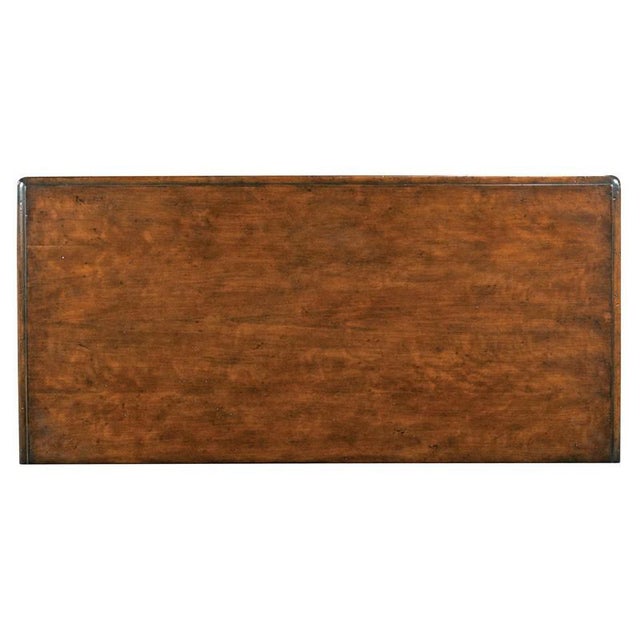 A rectangular molded top rests over five individual drawers veneered with cherry. The drawers are accented by intricate...