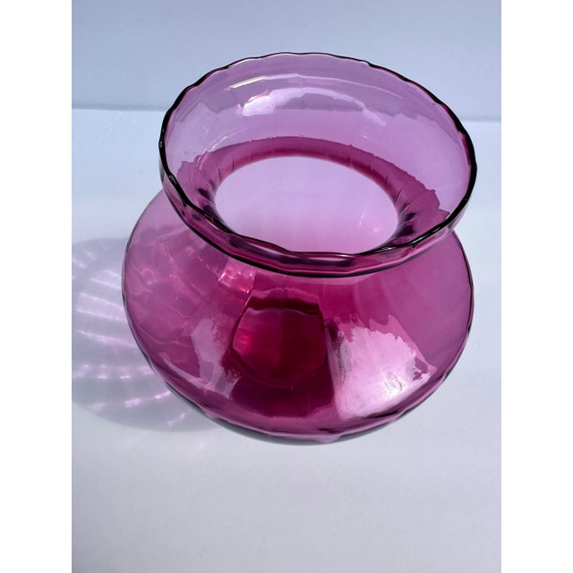 Cranberry glass Vase with lovely rim detail and traditional design of body and neck. Draping flowers in yellows, reds,...