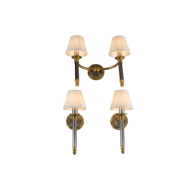 Set of three wall lights dating to the 1950s: two single-arm sconces and one double-arm sconce, providing four lights in...