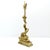 Large decorative doorstop in patinated cast brass, depicting a fantastical dolphin whose long tail is coiled around...