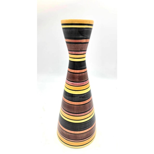 Offered is a vintage mid-century modern ceramic hourglass or "diabolo" style vase featuring horizontal multi-colored...