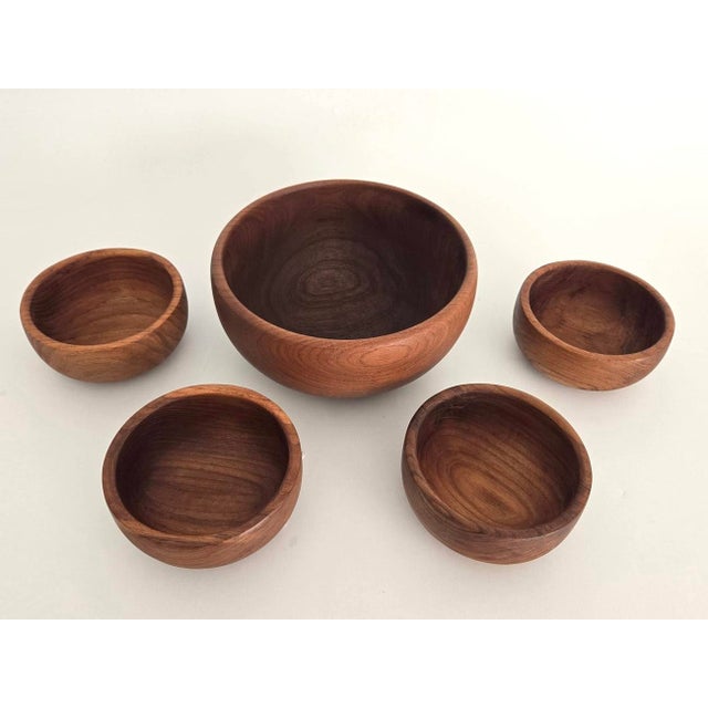 Offered is a set of hand turned teak wood bowls made in Thailand for GoodWood in the 1970s. They feature a deep bubble...