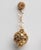 An unusual pair of 18K gold dimpled ball earrings dangling from a gold chain and granulated gold post. For pierced ears....