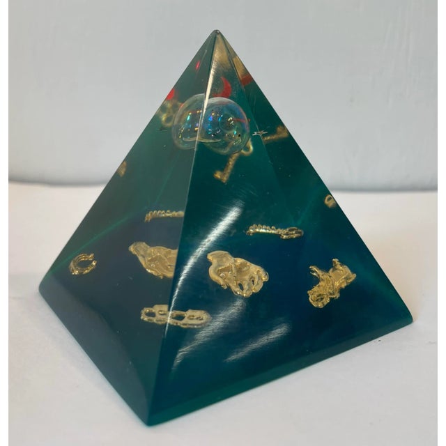 This vintage lucite paperweight has a moon and stars floating in the top and several gold shapes around bottom including a...