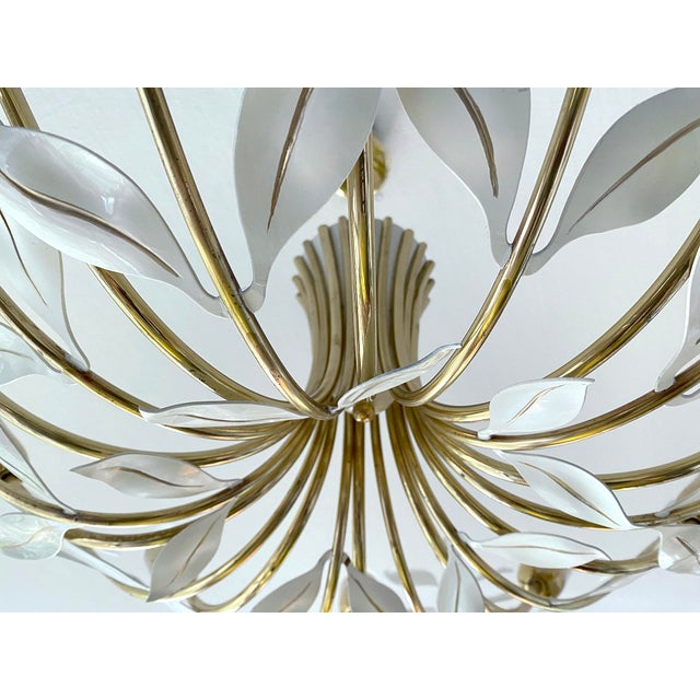 Large mid century pendant light featuring 10 brass curved spokes adorned with white leaves and handpainted gold highlight...