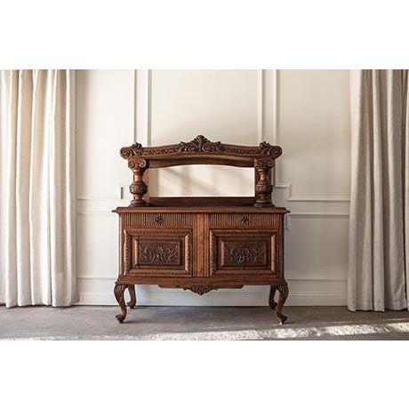 This Victorian Renaissance Revival carved oak sideboard, masterfully crafted circa 1880–1890, is a commanding expression...