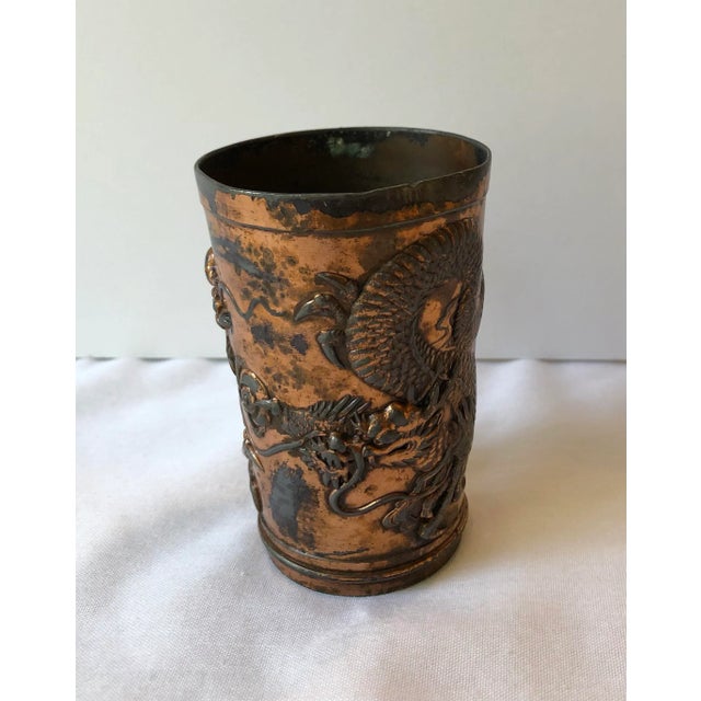 Vintage Japanese dragon cup with a copper plated surface.