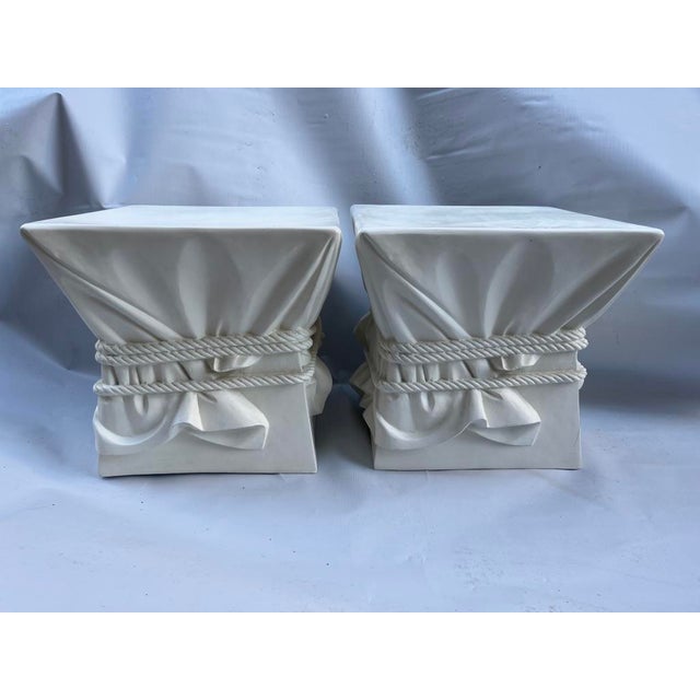A matching pair of vintage plaster trompe l'oeil draped fabric and rope square side tables or stools.