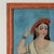 Provocative 19th century Indian reverse painting on glass of a young woman in a red hat with jewelry executed in a...