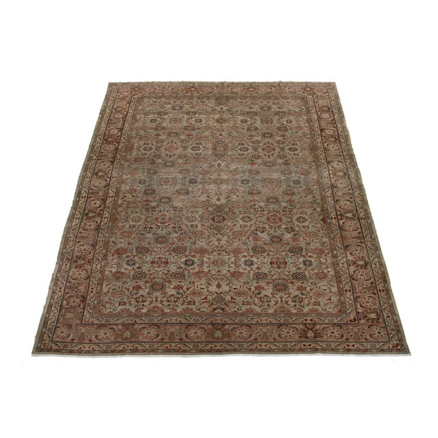 Experience the elegance of this beautiful antique Malayer hand-knotted wool rug, showcasing a rich brown field. This...
