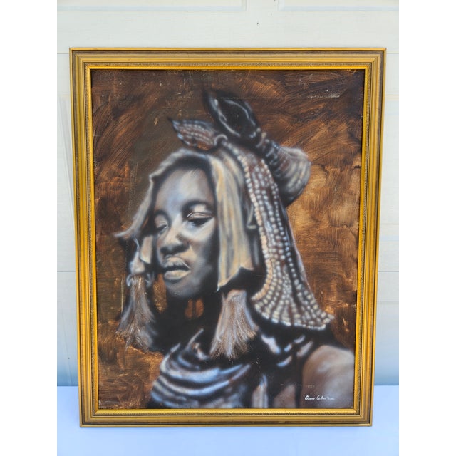 This oil on canvas is titled “Himba Woman” and is by Cape Town, South African artist Gavin Collins. The portrait has a...