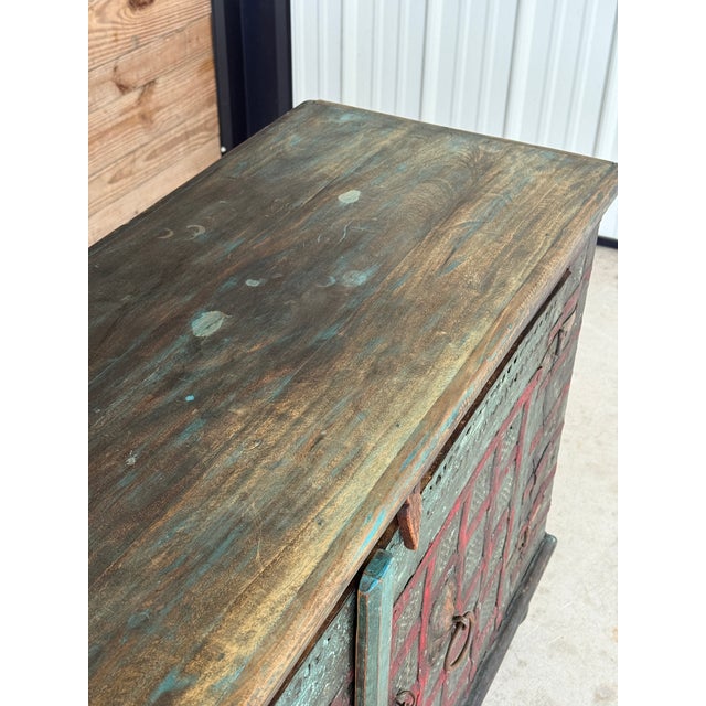 A striking antique Anglo-Indian cabinet, richly weathered with its original multi-layered painted finish in red and green...