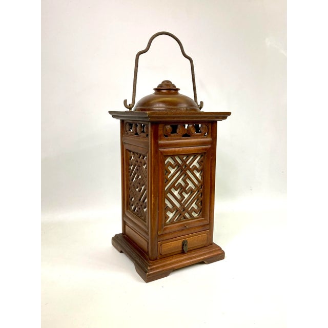 This is a handcrafted wooden lantern with a small drawer underneath. The lattice has paper glued to the side to create an...