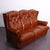 Beautiful brown Chesterfield-style sofa features distinctive button-tufting on the three high-back cushions. The seat...