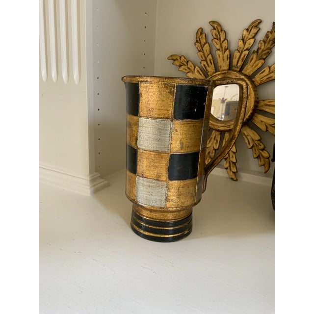 An Vintage large Italian Florentine gilded and hand painted heavy metal pitcher in a harlequin style. The pitcher has a...